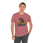 Man wearing a pink t-shirt with a dog graphic and text on a white background