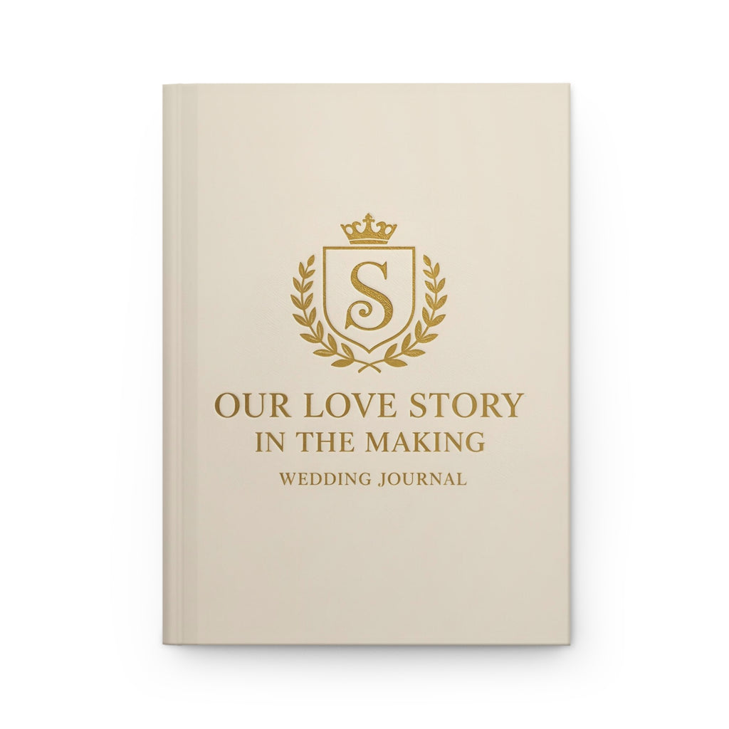 Beige wedding journal with gold text and emblem on a white background