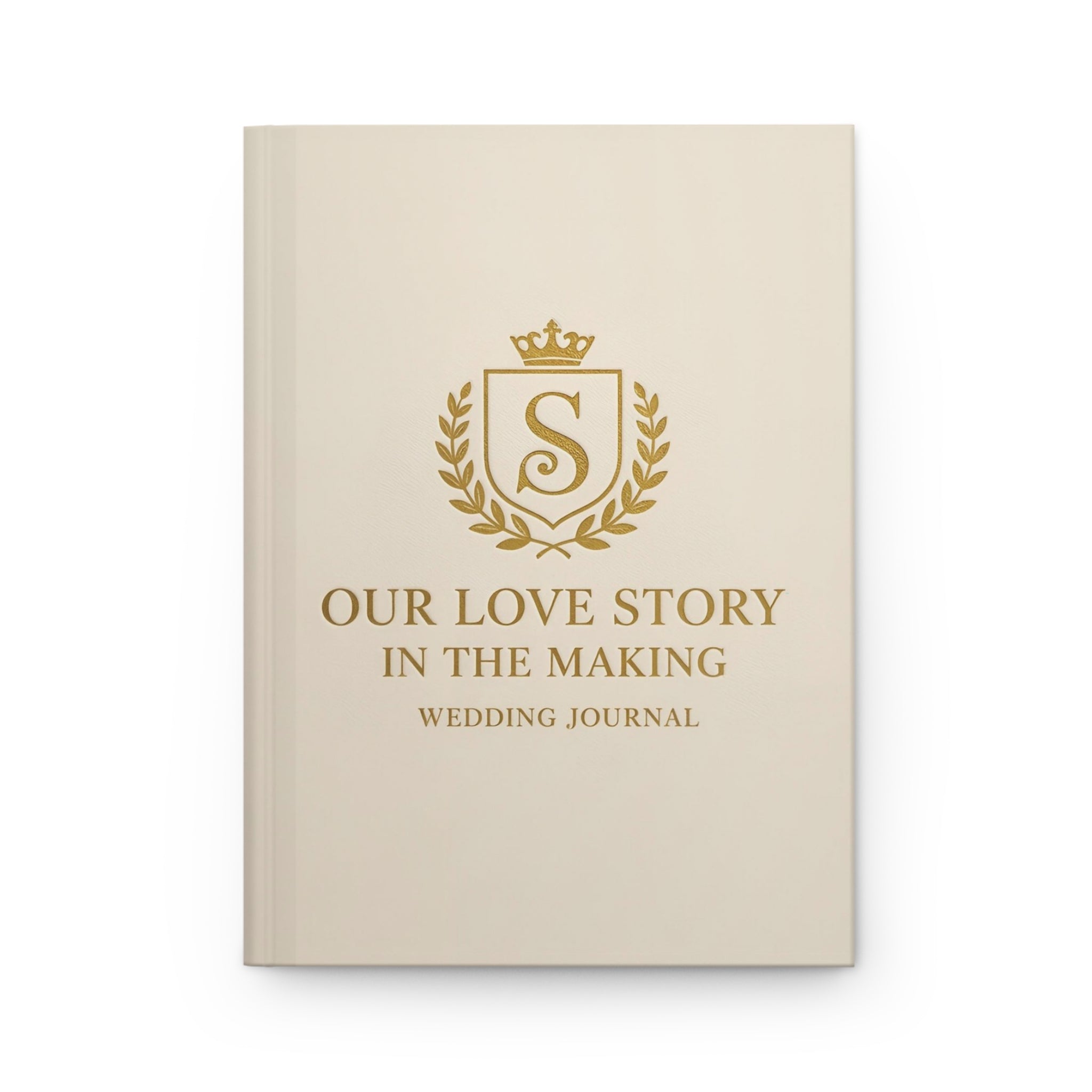 Beige wedding journal with gold text and emblem on a white background