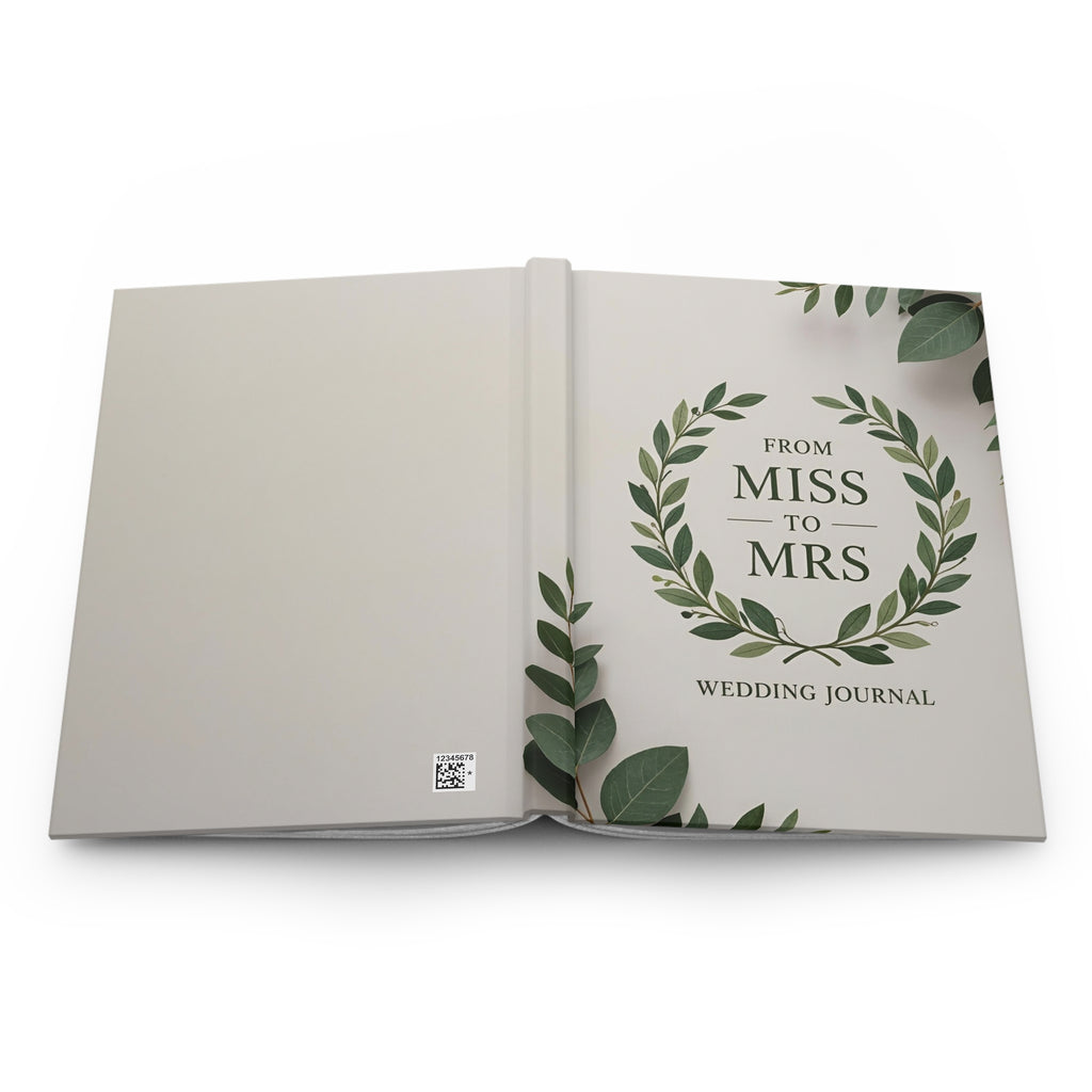 Open book titled 'From Miss to Mrs Wedding Journal' with green leaf design on a white background