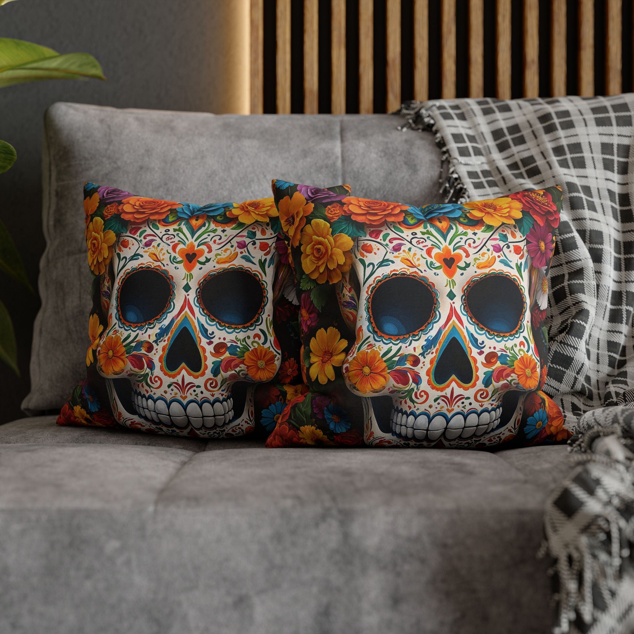 Colorful skull-themed pillows on a gray sofa with a wooden headboard in the background.