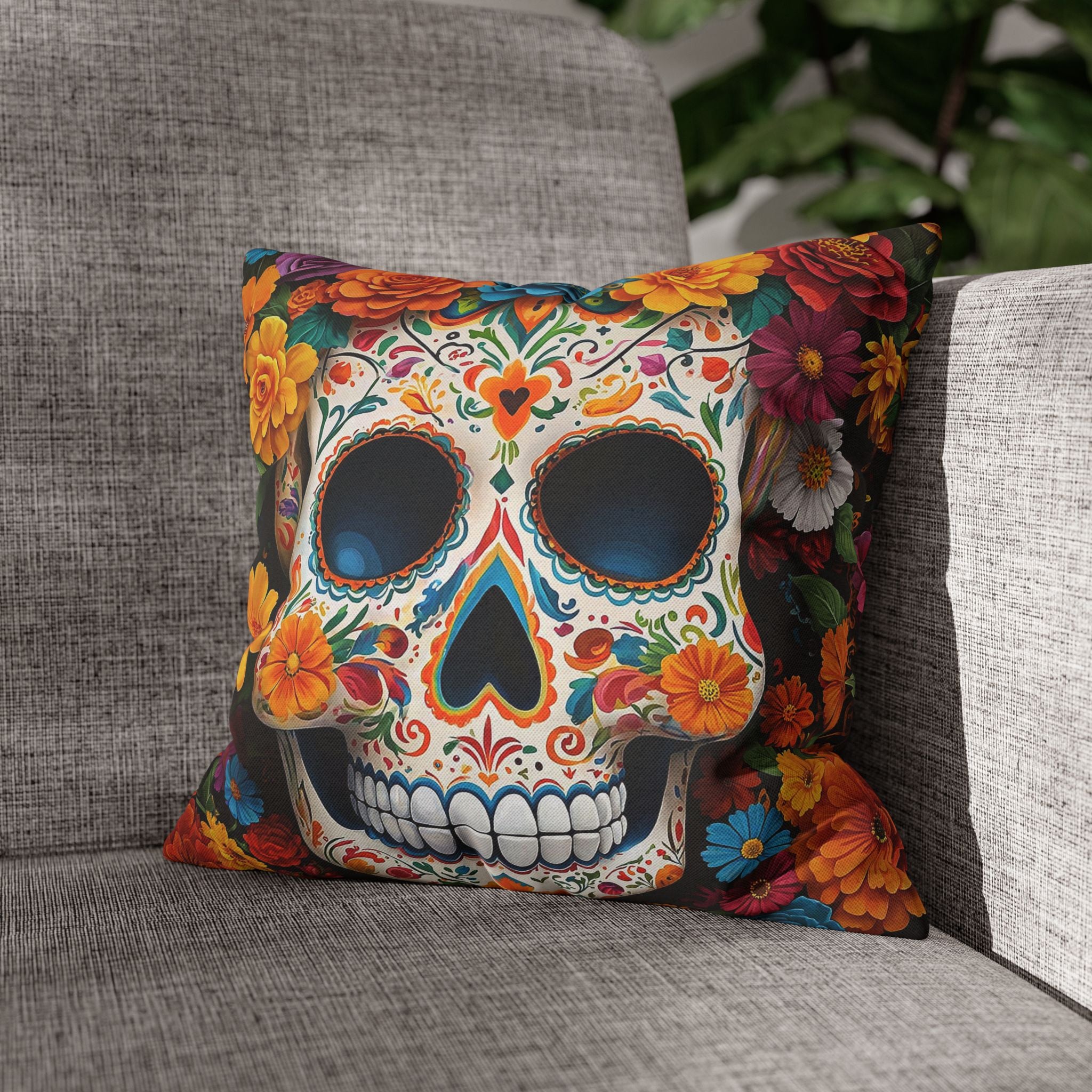 Decorative pillow with a colorful skull design on a gray couch.